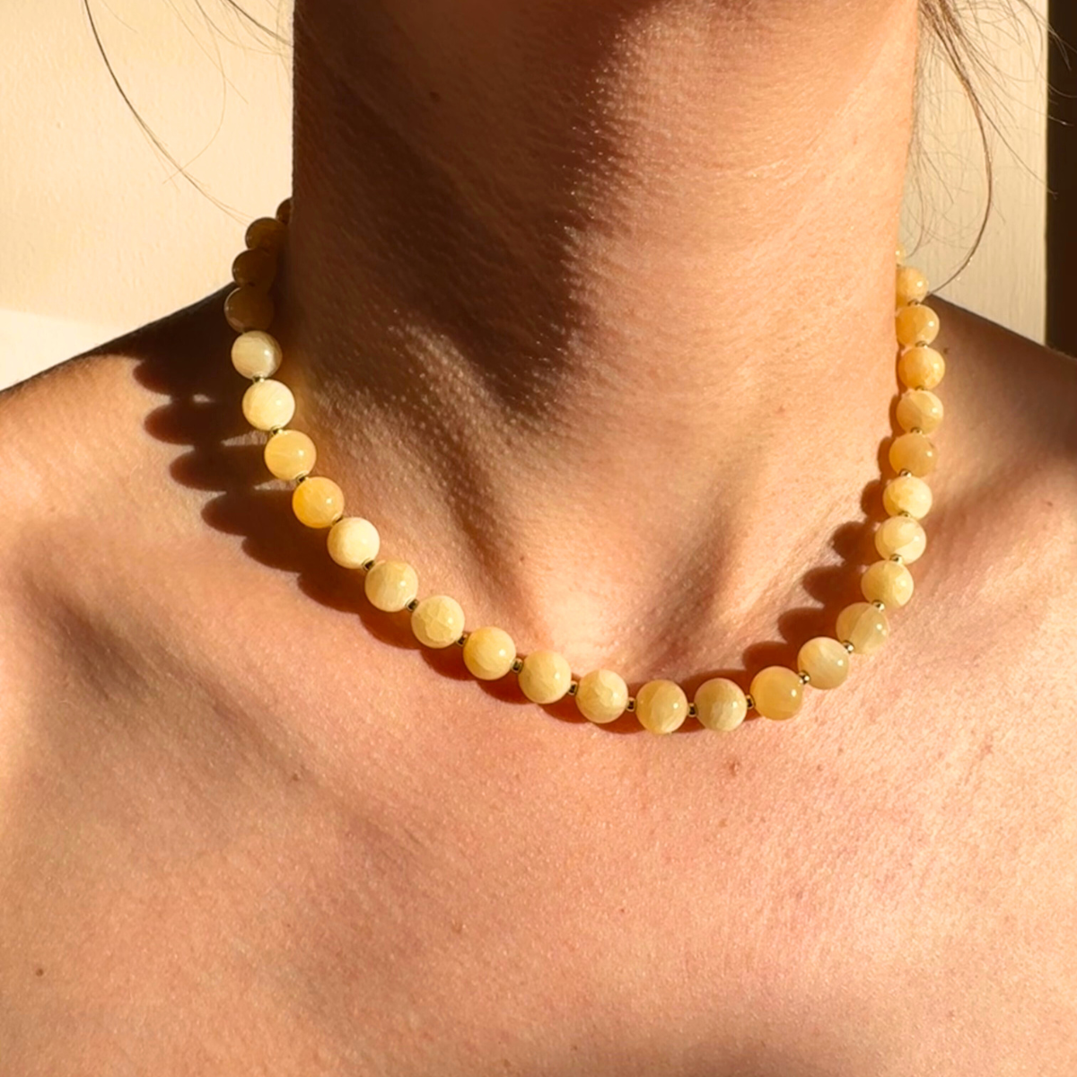 Wulfi necklace worn close in warm daylight